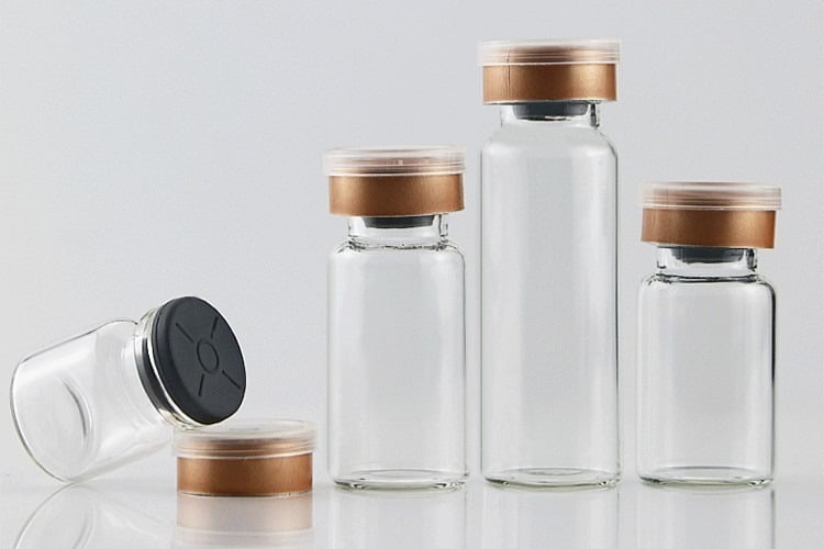 Crystal clear Type I borosilicate glass vials undergoing high-temperature sealing