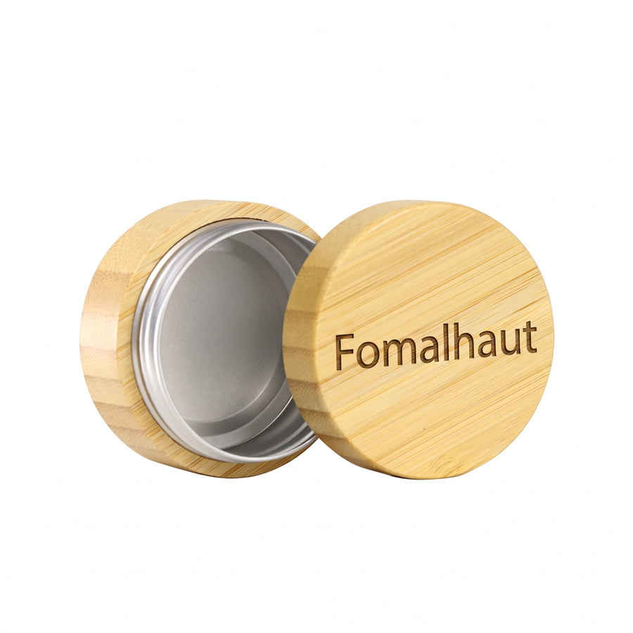High-definition close-up of a finely engraved brand logo on a natural bamboo cosmetic cap