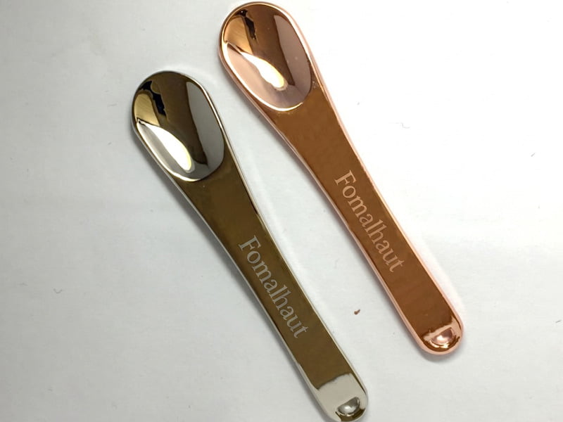 Laser logo on a cosmetic spatula handle