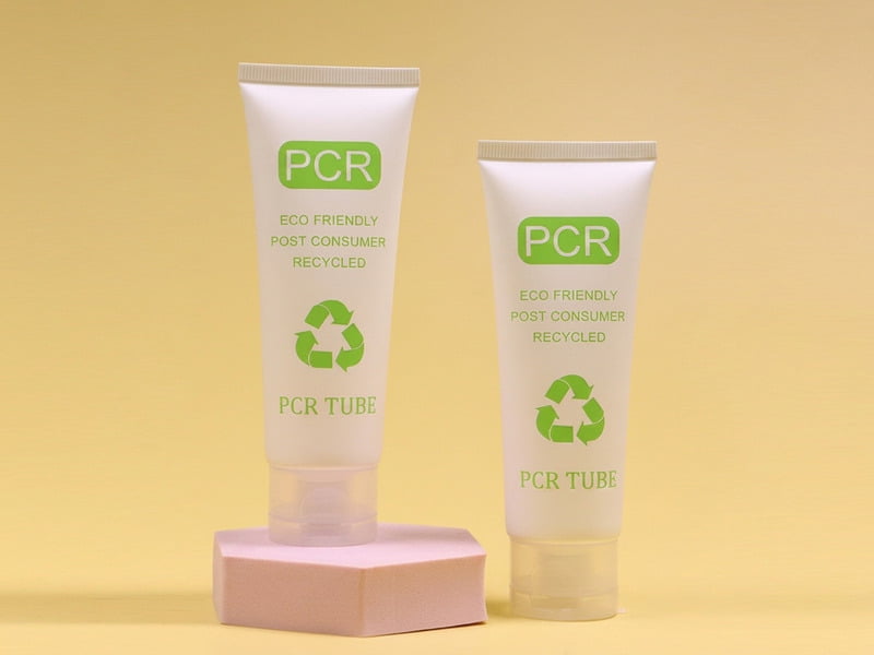 Matte finish eco-friendly cosmetic tubes with recycling symbols and sugarcane botanical elements