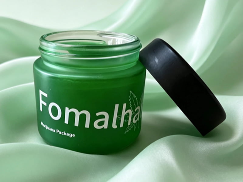 Green cosmetic jar with white silk screen printing