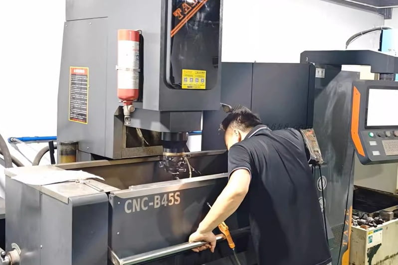 Operator working at mold machining equipment for cosmetic packaging