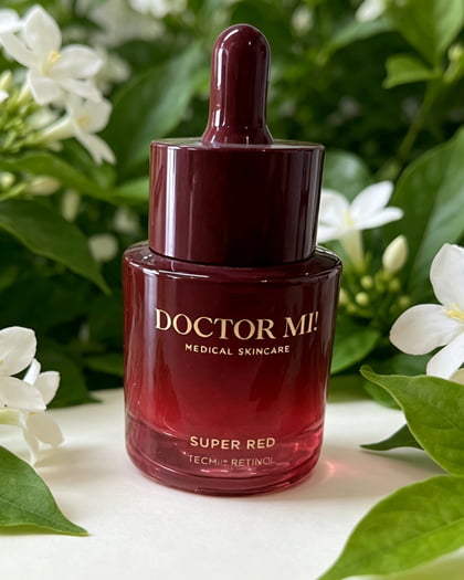 Red glass dropper bottle with spray coating and gold hot-stamped lettering