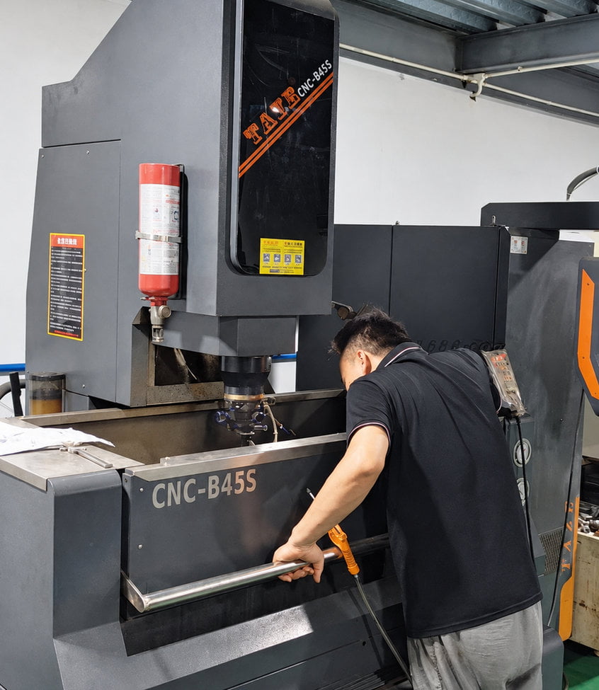 Operator working at cosmetic packaging mold workshop equipment
