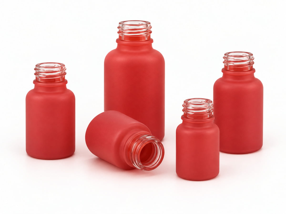 Red spray-coated essential oil bottles in several sizes